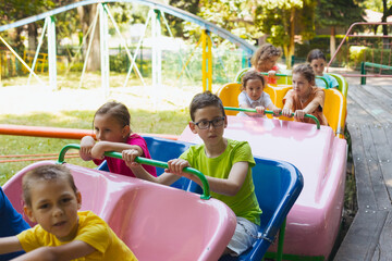 Wall Mural - The happy little children are resting in the amusement park