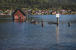 summer vacation in the mountains. spring flood on the lake. a flooded pier and a wooden house.