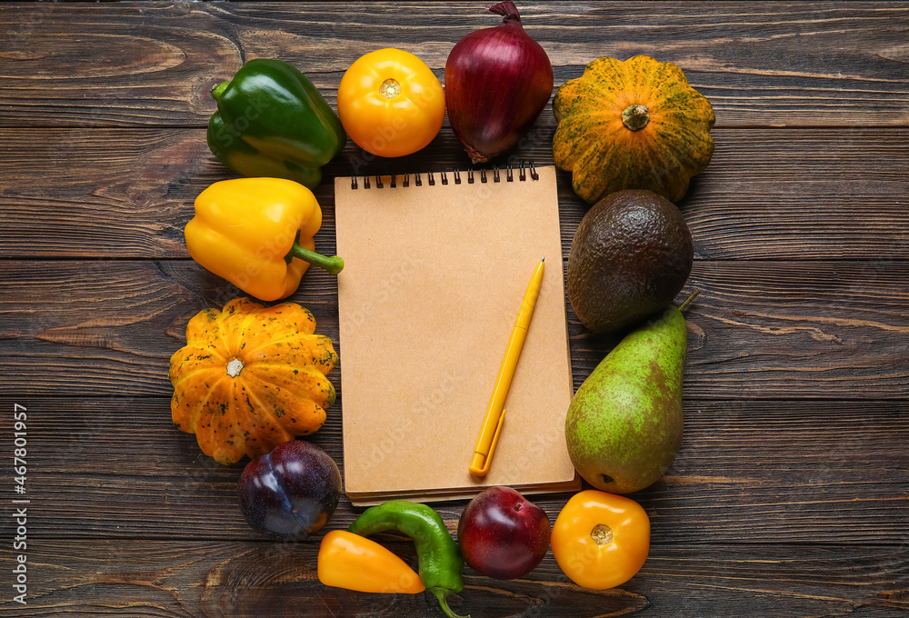 Blank notebook, pen, vegetables and fruits on wooden background. Vegan Day