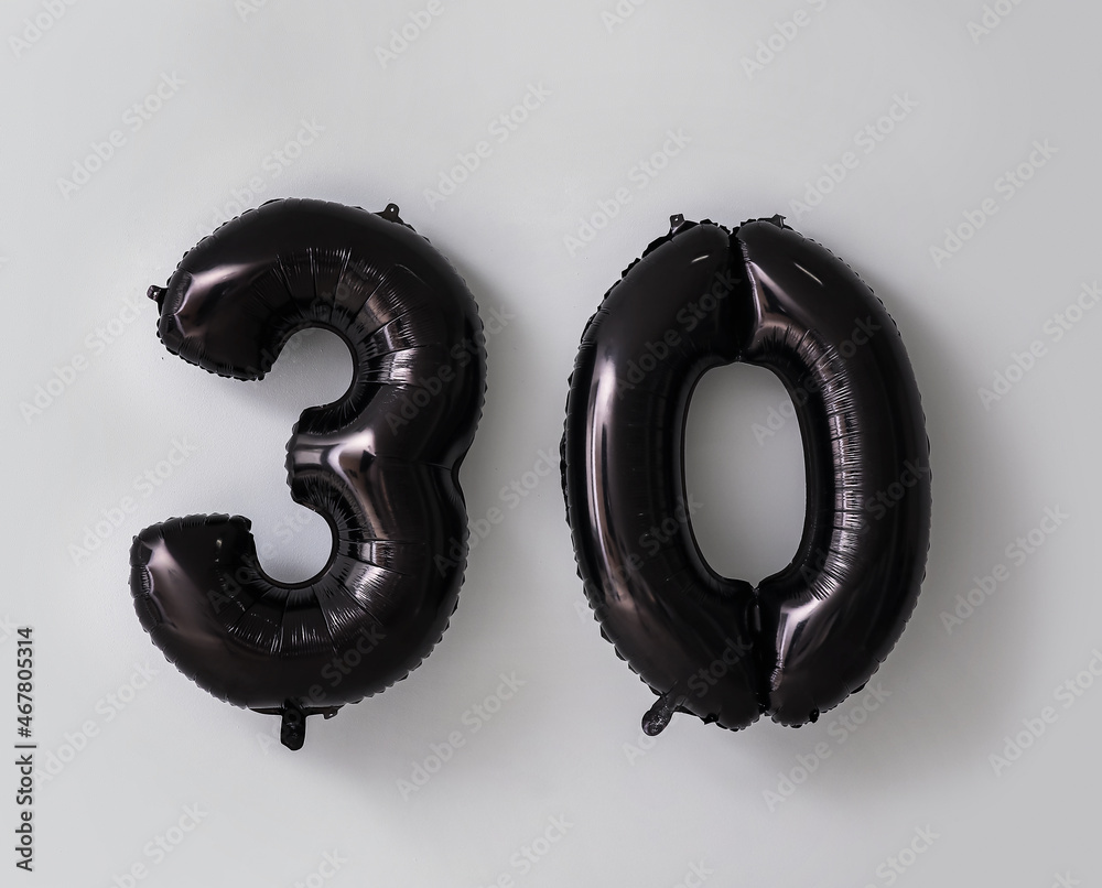 Figure 30 made of black balloons on light background