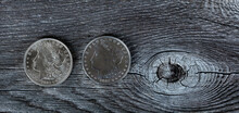1921 And 2021 Morgan Silver Dollars For Hundredth Anniversary On Vintage Wood Background