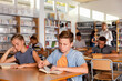© JackF - Upset efficient boy and girl reading books during lesson in classroom