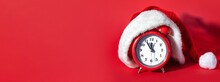 Red Clock With Christmas Santa Hat. Time For Christmas Shopping Concept. Blank Copy Space For Text.