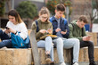 © JackF - Four teenagers chatting on their smartphone on walking