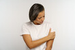 © DimaBerlin - Unhappy black woman suffer from pain in arm touching injured shoulder with painful face expression. Young african american female with hand bone fracture or dislocation. Injury or arthritis disease