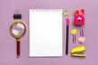 Stationary, back to school, summer time, creativity and education concept School supplies - magnifier, pencils, pen, paper clips, stapler and notepad on purple background, flat lay Mock up Top view