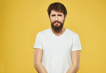 Wall Mural - emotional man in a white t-shirt expressive look discontent Studio