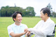 © siro46 - 介護士と車椅子に乗る高齢者　屋外
