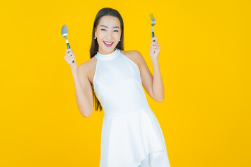 Wall Mural - Portrait beautiful young asian woman smile with spoon and fork