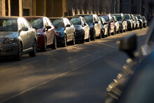 Cars Parked Tightly Along The Roadside In The City