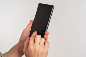 Poster - Phone in hand. Woman hands off by phone. Smartphone for application demonstration. Place for application on cellphone screen. Cellphone in human hands on light background. Black display phone