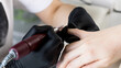 © Виктория Попова - A manicurist removes gel polish from nails using a milling cutter. Hardware manicure close-up. Coating shellac on nails