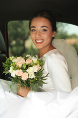 Poster - Young bride wearing wedding dress with beautiful bouquet in automobile