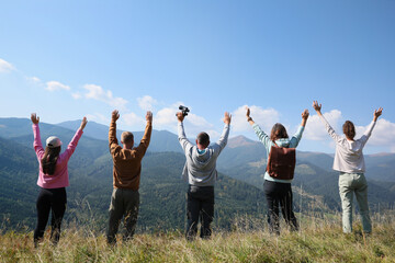 Poster - Group of people spending time together in mountains, back view