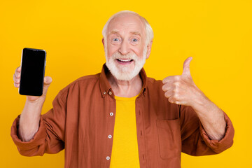 Poster - Photo of old man hold phone touchscreen raise thumb up give feedback wear brown shirt isolated yellow color background