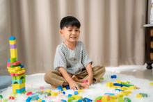 Children Playing Colorful Wooden Blocks In Home,Sitting On Floor,Depression Stress Or Frustration.