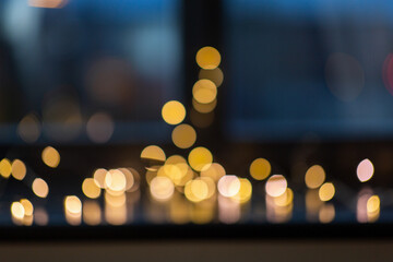 Wall Mural - christmas, holidays and illumination concept - golden lights on window sill in darkness