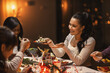 © Syda Productions - holidays, party and celebration concept - multiethnic group of happy friends having christmas dinner at home