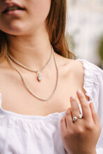 Close-up Of A Female Jewelry On A Girl's Neck, A Beautiful Silver Necklace