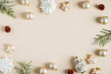 Frame Of Elegant Christmas Decorations On Beige Background. Christmas Card Design. Flat Lay, Top View, Copy Space.