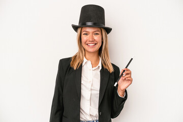 Poster - Young caucasian wizard woman holding wand isolated on white background happy, smiling and cheerful.