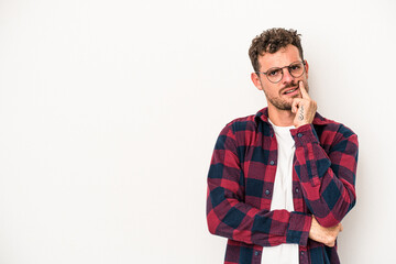 Young caucasian man isolated on white background looking sideways with doubtful and skeptical expression.