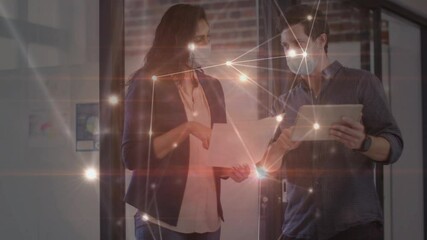 Poster - Animation of network over male and female creative colleagues in face masks talking in office