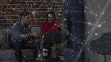 Poster - Animation of network over male and female colleague using laptop on couch in office