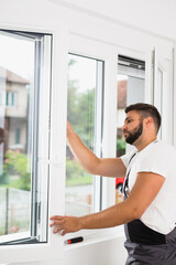 worker fixing pvc windows indoor