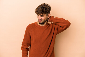 Wall Mural - Young arab man isolated on beige background suffering neck pain due to sedentary lifestyle.