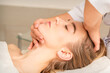 © okskukuruza - Cosmetologist hands doing facial massage on forehead and chin of young female at spa salon
