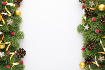 Top view photo of gold christmas tree balls pine cones red berries glowing stars and serpentine on pine branches on isolated white background with empty space