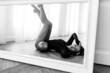 © Дмитрий Бесов - girl gymnast, is engaged with gymnastic objects in a light room, she is in a black leotard, performs exercises.