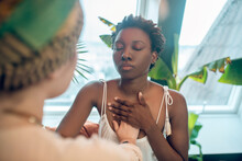 A Healer Working With A Dark-skinned Woman