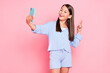 © deagreez - Photo of funky pretty school girl dressed blue clothes smiling tacking selfie showing v-sing isolated pink color background