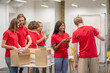 © zinkevych - Young people in red looking busy while working with donations distributing