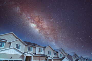 Complex houses against the composite milky way sky