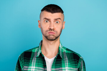 Sticker - Photo of angry unhappy young man bad mood face cheeks blow air negative isolated on blue color background