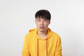 Young good looking Asian chinese malay man pose face body expression mode emotion on white background don’t care funny ignore look yes up what ever