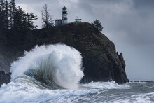 Giant Waves Crashing Under Light House During King Tides On The Washington Coast, Cape Disappointment State Park