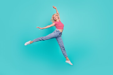 Poster - Photo of funky adorable young woman dressed red t-shirt smiling jumping high isolated teal color background