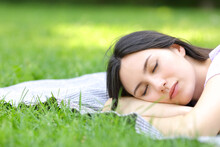 Asian Woman Sleeping Lying On The Grass
