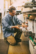 © Maskot - Senior male entrepreneur checking frames while working in workshop