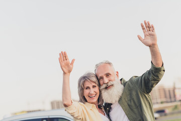 Canvas Print - Photo of old people man woman wave hands hello good mood enjoy car park outdoors outside in urban city