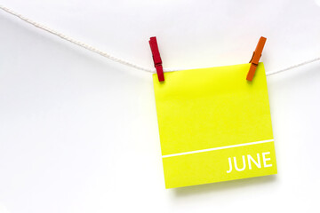 June. Month, Calendar month. Paper cards with calendar day hanging rope with clothespins on white background. Summer , month of the year concept.