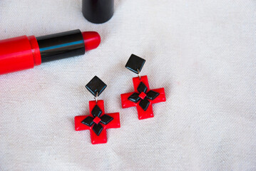 Wall Mural - Geometric earrings in black and red of polymer clay. Fashion background.