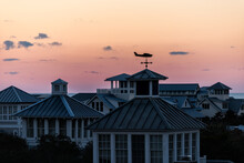 High Angle Aerial View On Colorful Sunset Twilight In Seaside, Florida With Wooden Roof Terrace Building Towers And Silhouette Of Weather Vanes