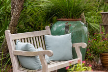 Outdoor Green Garden Beach Patio Wooden Bench In Backyard Porch Of Home With Nobody In Florida Tropical House Pillows And Plants