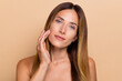 © deagreez - Portrait of nice-looking cute long-haired woman touching soft fresh skin lifting uplift effect isolated over beige pastel color background