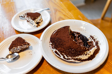 plates with two slices of vanilla mascarpone traditional italian tiramisu with egg yolks gelato base